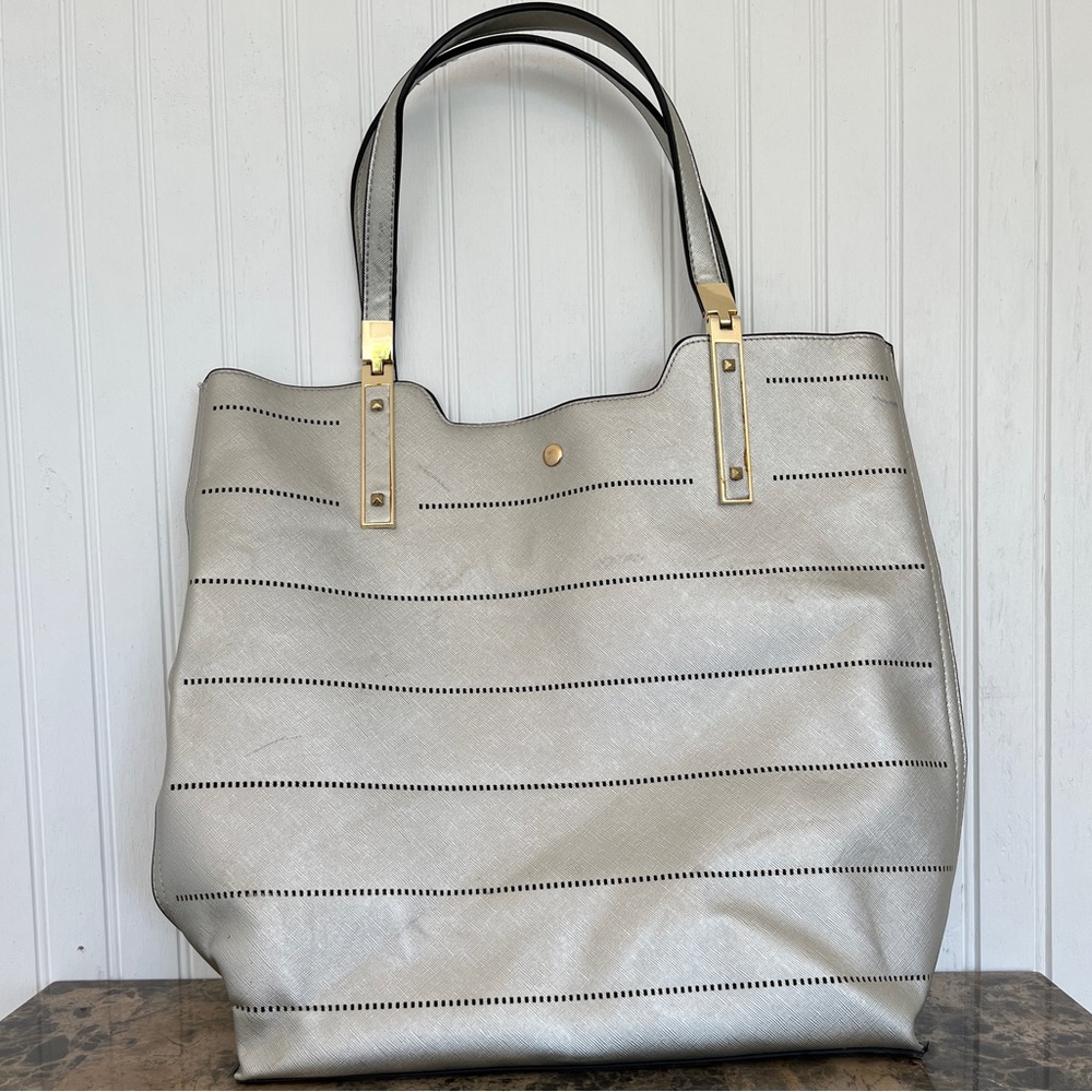 Large, silver purse/ tote bag with gold accents and black interior